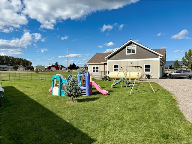 view of jungle gym with a lawn