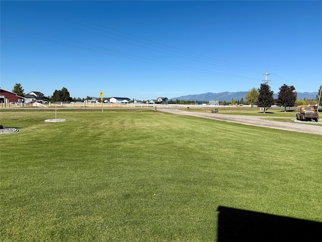 view of property's community with a mountain view and a yard