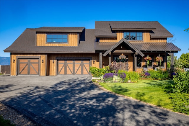 view of front of property with a front yard and a garage