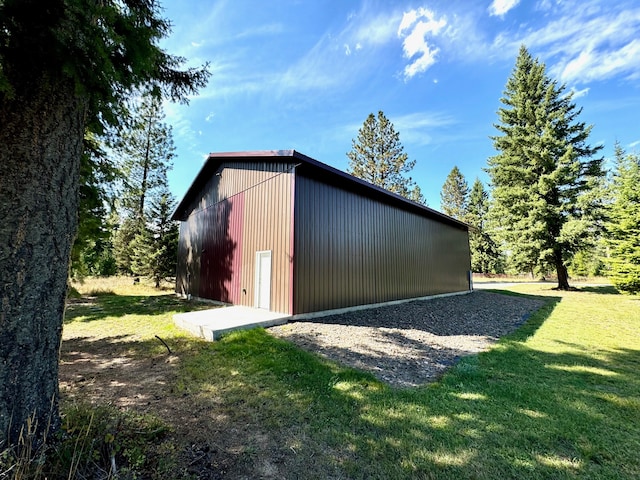 view of outbuilding featuring a lawn