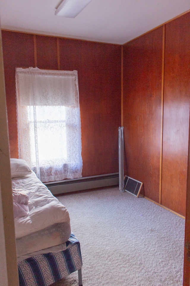 bedroom featuring carpet floors and a baseboard heating unit