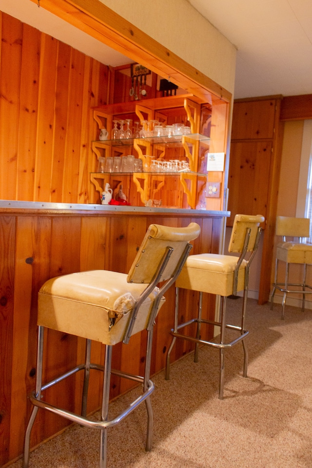 bar with carpet floors and wooden walls