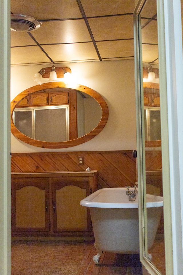 bathroom featuring wood walls