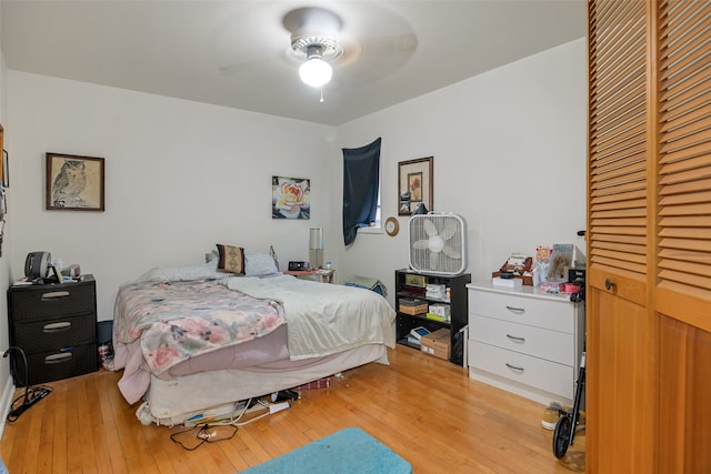 bedroom with light hardwood / wood-style flooring and ceiling fan