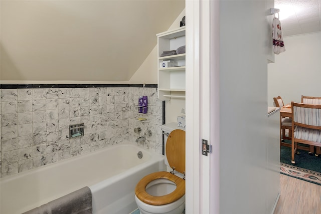 bathroom featuring toilet, hardwood / wood-style floors, and a tub