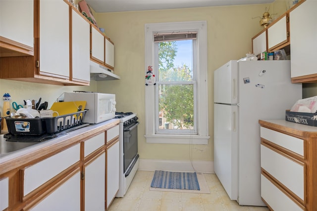 kitchen featuring white cabinets and white appliances