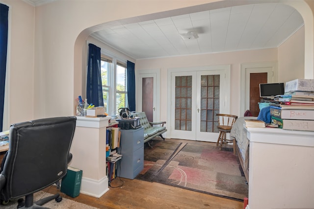 office with ornamental molding, french doors, and dark hardwood / wood-style floors