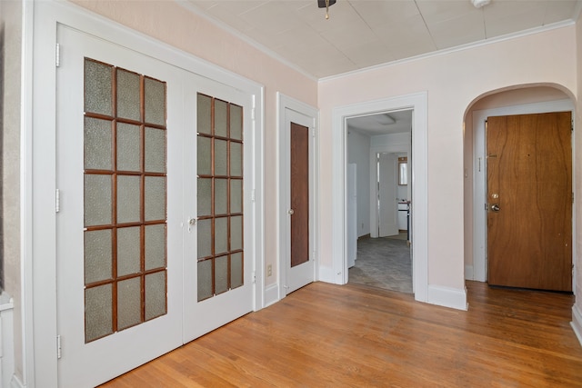 interior space with light wood-type flooring and ornamental molding