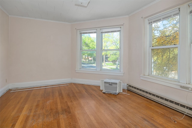 unfurnished room featuring light hardwood / wood-style floors, a baseboard radiator, and ornamental molding