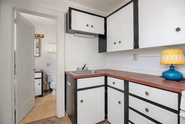 kitchen featuring white cabinets and sink