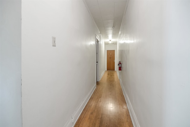 hallway with light hardwood / wood-style flooring