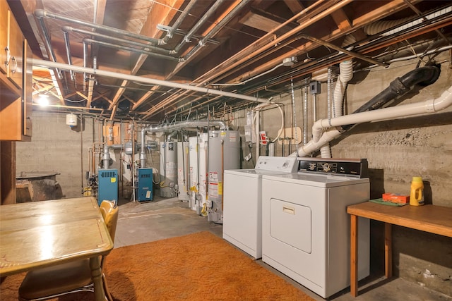 basement featuring washing machine and clothes dryer and gas water heater