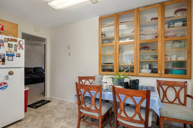 dining area featuring a textured ceiling