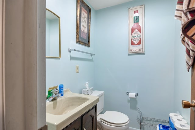 bathroom with toilet and vanity