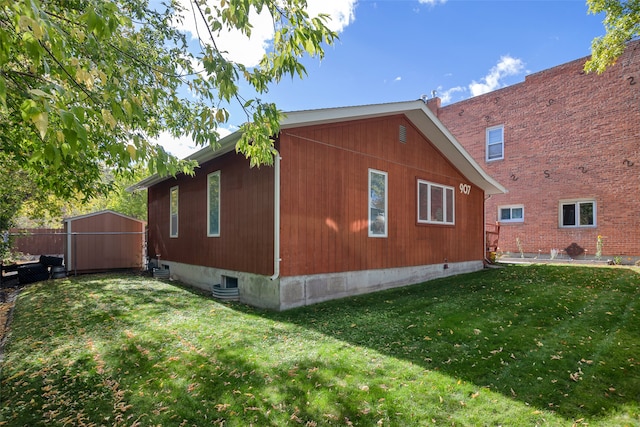 view of property exterior featuring a lawn and a storage shed