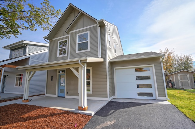 view of front of home featuring a garage, covered porch, and a storage unit