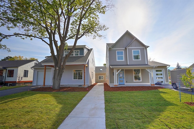 view of front of property with a porch, a garage, and a front lawn