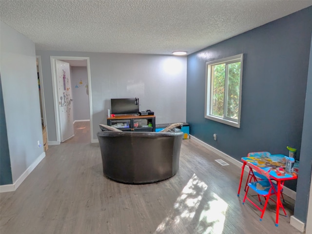 home office featuring hardwood / wood-style flooring and a textured ceiling