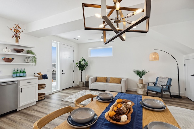 living area with light wood-style flooring, baseboards, and a notable chandelier