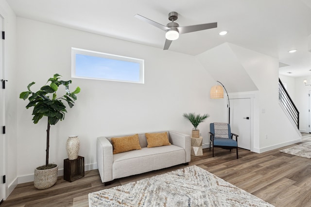 sitting room with recessed lighting, stairs, and wood finished floors