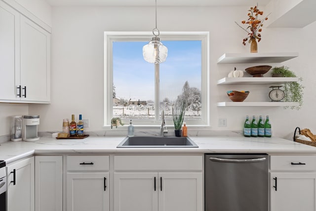 kitchen with a sink, decorative light fixtures, white cabinets, stainless steel dishwasher, and open shelves