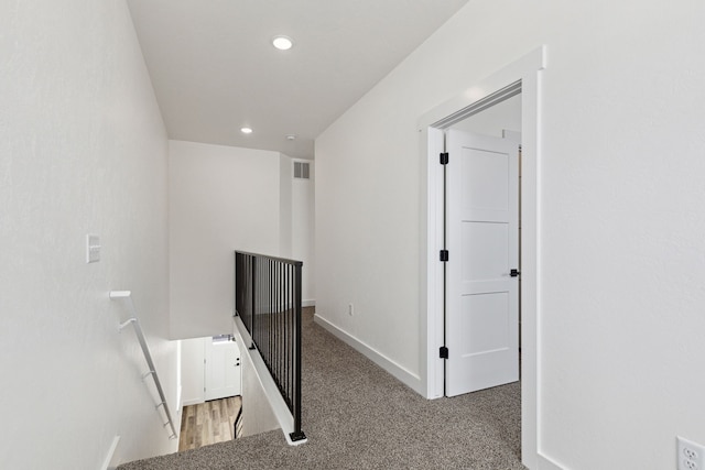 corridor featuring recessed lighting, visible vents, an upstairs landing, baseboards, and carpet floors