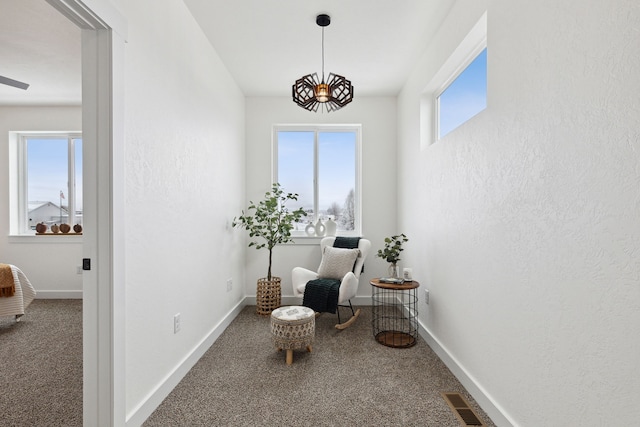 sitting room featuring baseboards, visible vents, and carpet