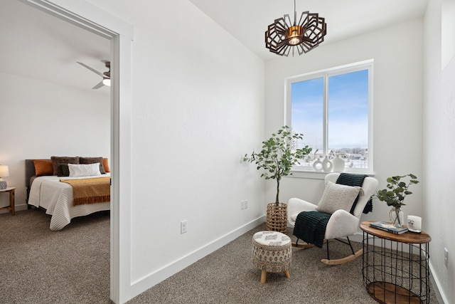 sitting room featuring ceiling fan, carpet floors, and baseboards