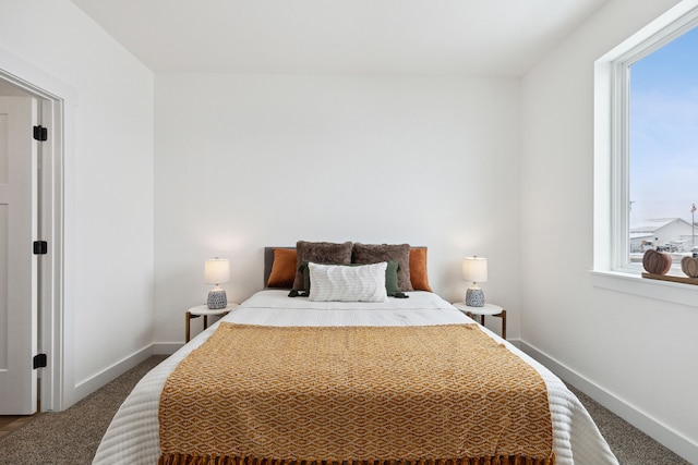 bedroom featuring baseboards and carpet