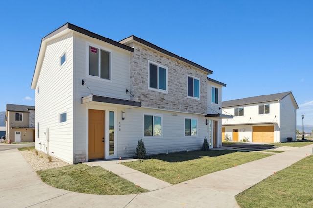 view of front of house featuring a front lawn and stone siding