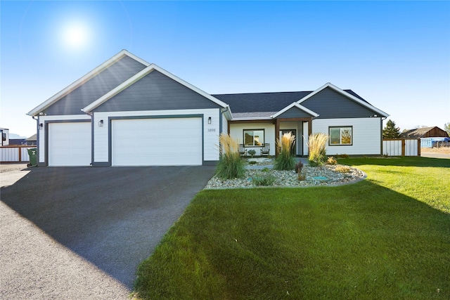 ranch-style home with a garage and a front lawn