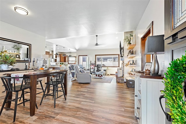 dining space with ceiling fan and light hardwood / wood-style floors