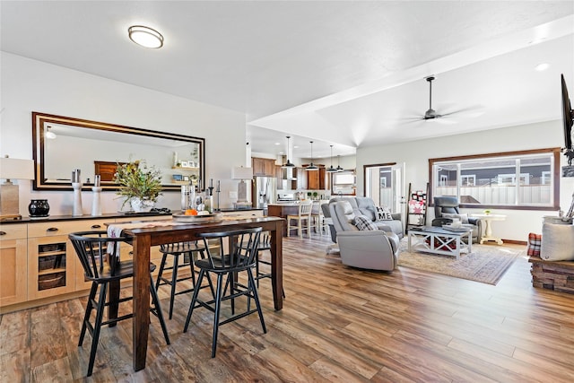 dining room featuring wine cooler, ceiling fan, and wood-type flooring