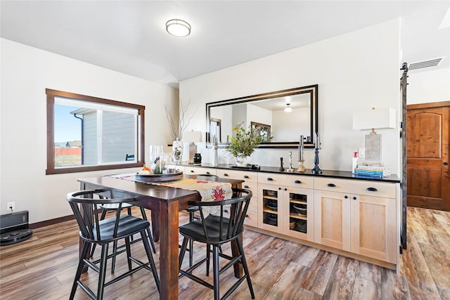 kitchen featuring hardwood / wood-style floors and light brown cabinets