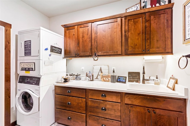 clothes washing area featuring sink and stacked washer / drying machine