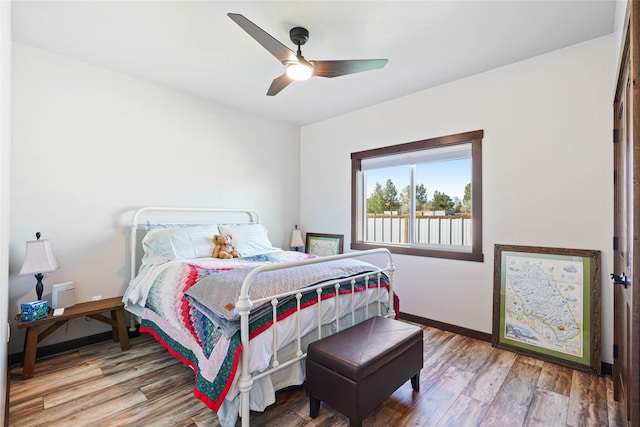 bedroom with hardwood / wood-style flooring and ceiling fan