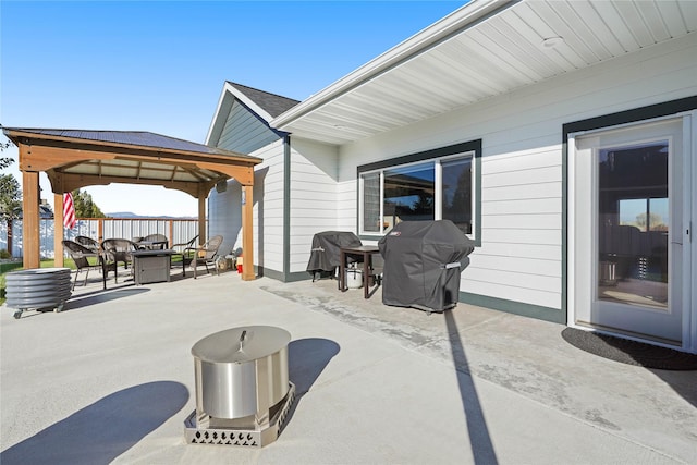 view of patio featuring a gazebo, an outdoor hangout area, and grilling area