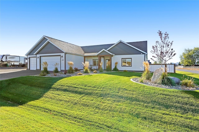 view of front facade with a front yard and a garage