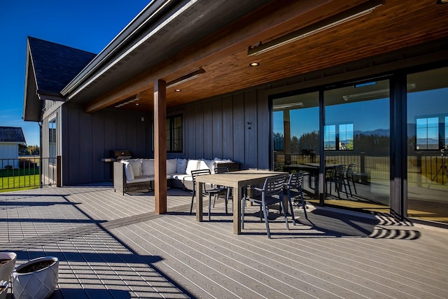 wooden terrace featuring outdoor dining space and an outdoor living space