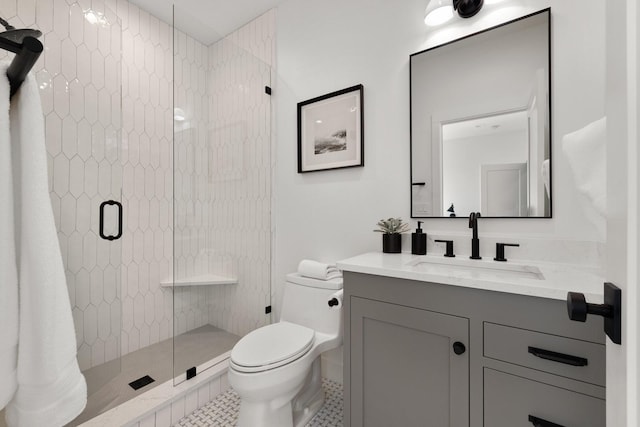 full bath with a shower stall, vanity, toilet, and tile patterned floors