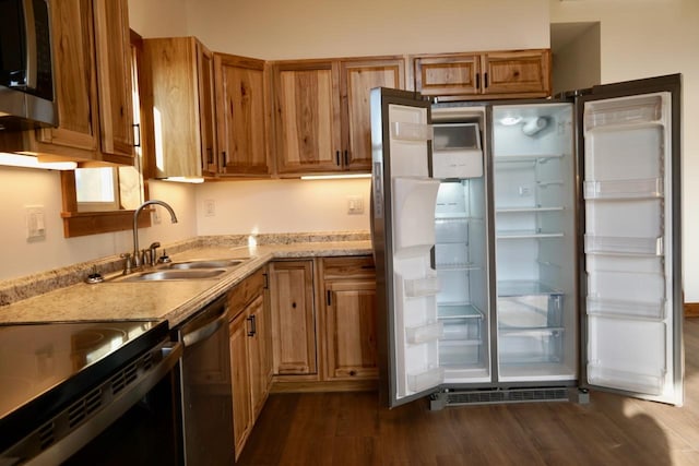 72 River Ct N, Eureka, MT 59917 - kitchen featuring brown cabinetry, dark wood finished floors, a sink, and appliances with stainless steel finishes