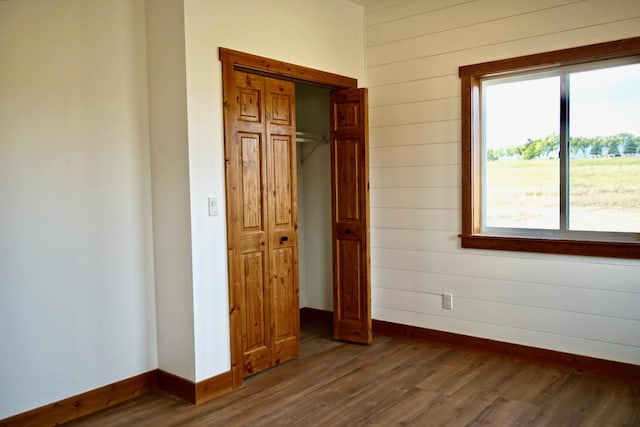 72 River Ct N, Eureka, MT 59917 - unfurnished bedroom with a closet, baseboards, multiple windows, and dark wood finished floors