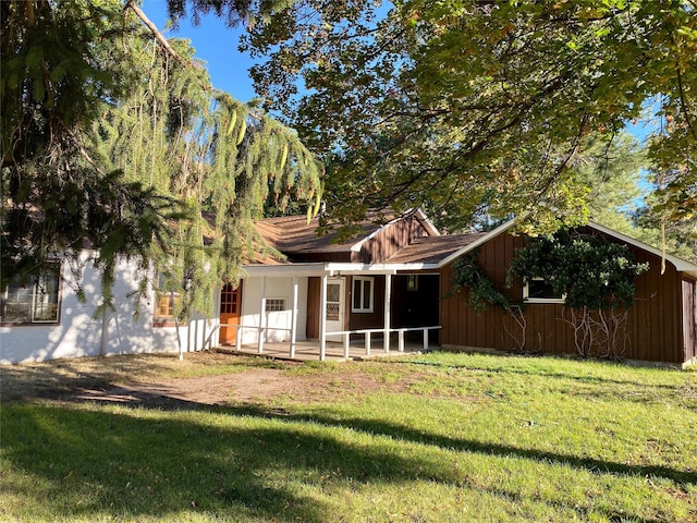 rear view of house featuring a lawn