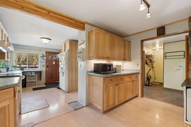 1627 Foothill Rd, Kalispell, MT 59901 - kitchen with freestanding refrigerator, stainless steel microwave, light wood-type flooring, extractor fan, and dark countertops