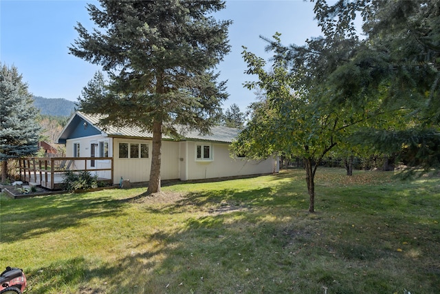 view of yard featuring a deck with mountain view