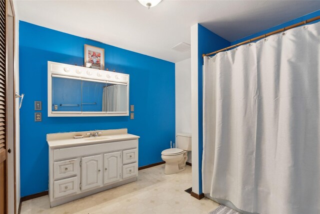 1627 Foothill Rd, Kalispell, MT 59901 - bathroom featuring toilet, vanity, baseboards, and tile patterned floors
