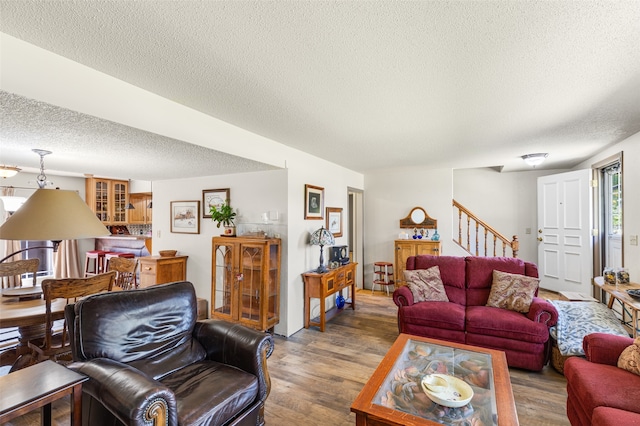 living room featuring a textured ceiling and hardwood / wood-style floors