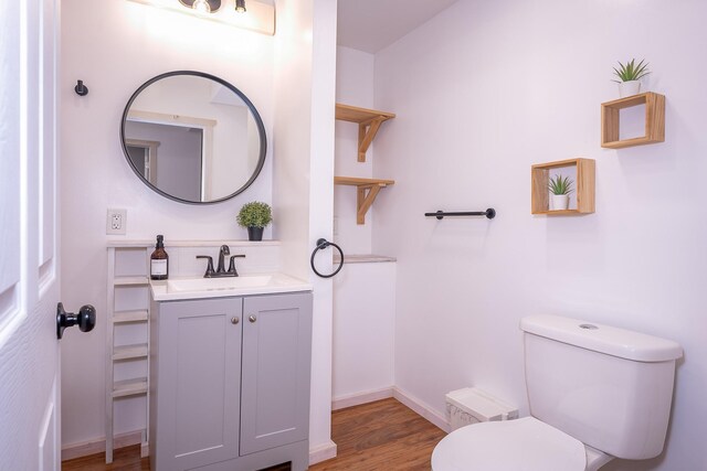 44 Copper Ridge Rd, Trout Creek, MT 59874 - half bathroom with toilet, vanity, wood finished floors, and baseboards