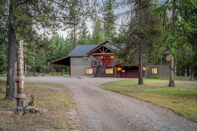 44 Copper Ridge Rd, Trout Creek, MT 59874 - rustic home with stairway, an attached carport, and dirt driveway