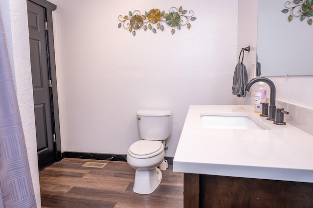 44 Copper Ridge Rd, Trout Creek, MT 59874 - bathroom with visible vents, wood finished floors, vanity, and toilet
